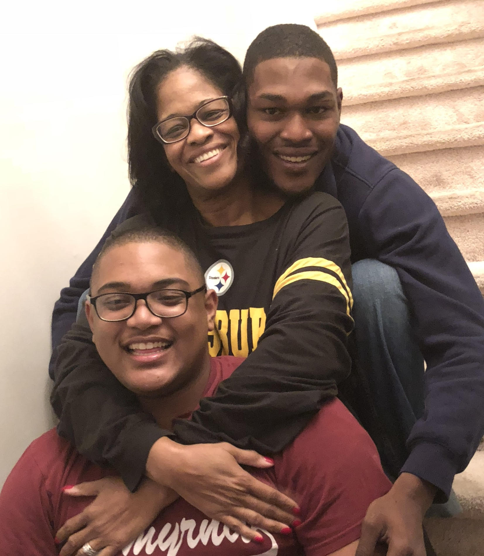 Dawn Moore with sons Derrick, 29 (upper right) and Jamar, 23 (lower left)